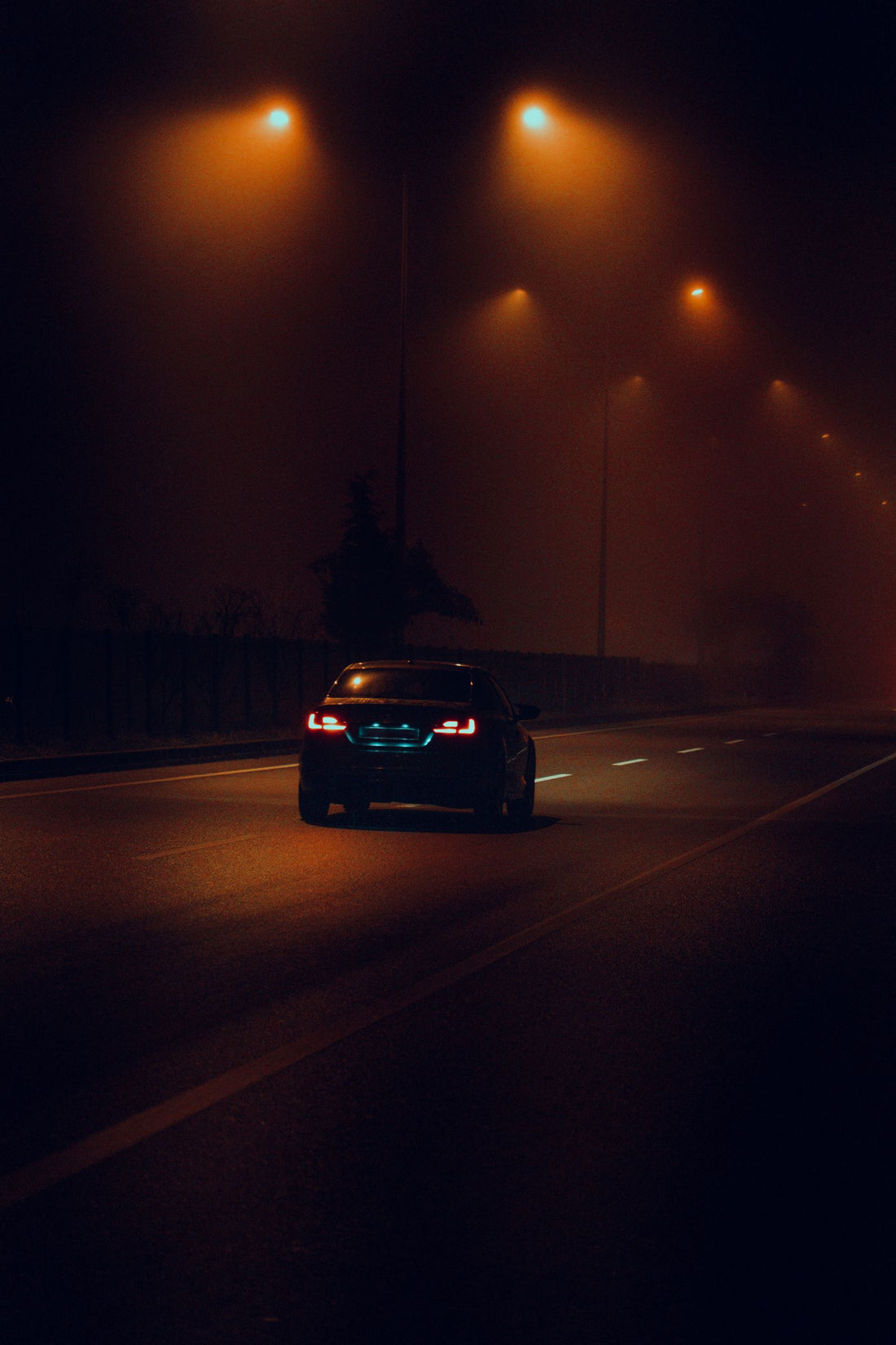 Car driving on a highway at night during a long road trip