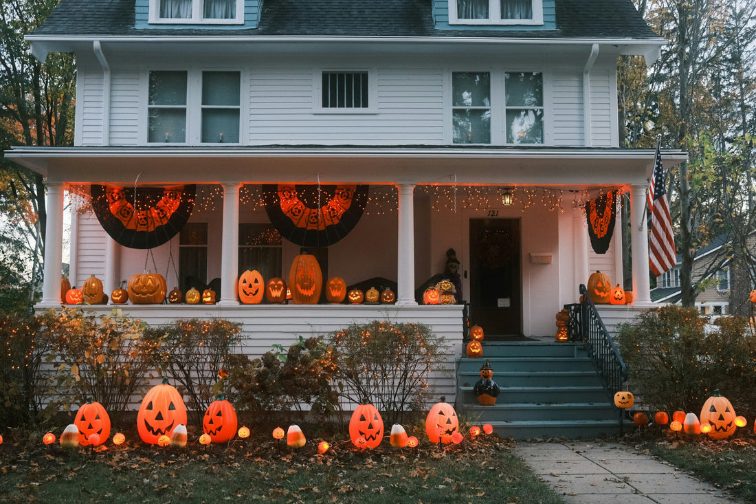 House decorated for Halloween with pumpkins and lights