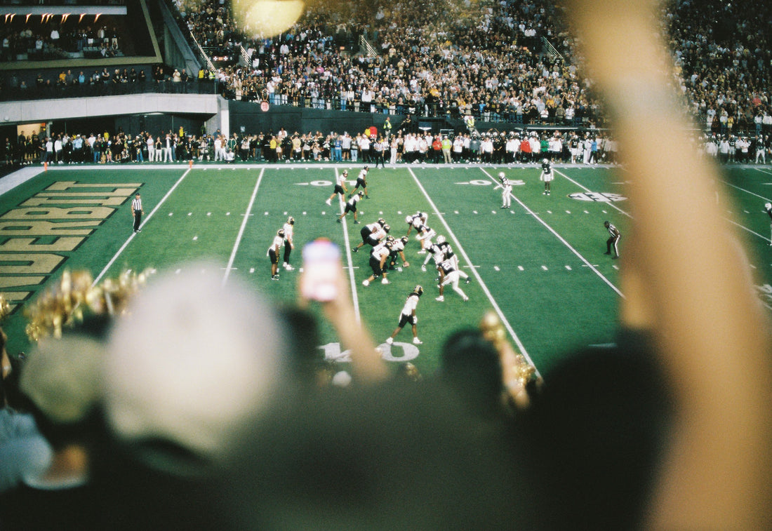 American football game in a packed stadium